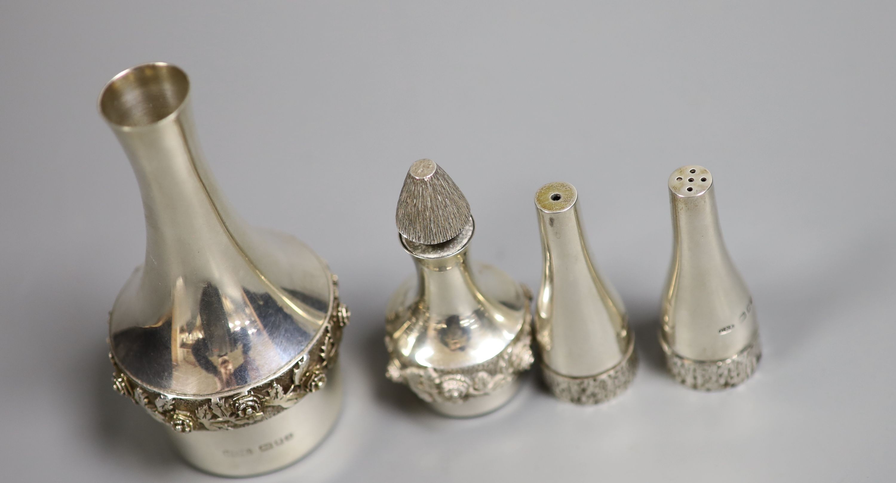 A pair of small modern silver bottle shaped condiments by Christopher Nigel Lawrence, 59mm and two other items by House of Lawrian, the largest, London, 1978.